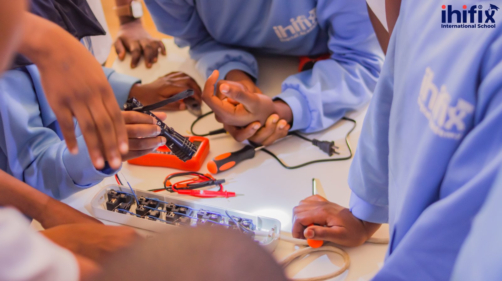 Students learning robotics at Ihifix International School
